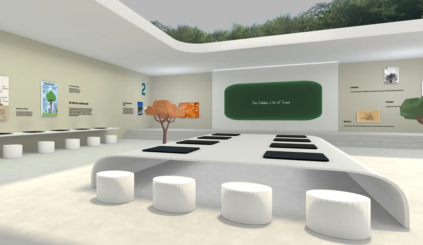 A Kunstmatrix 3D exhibition with wall texts, framed works and seating around a central table