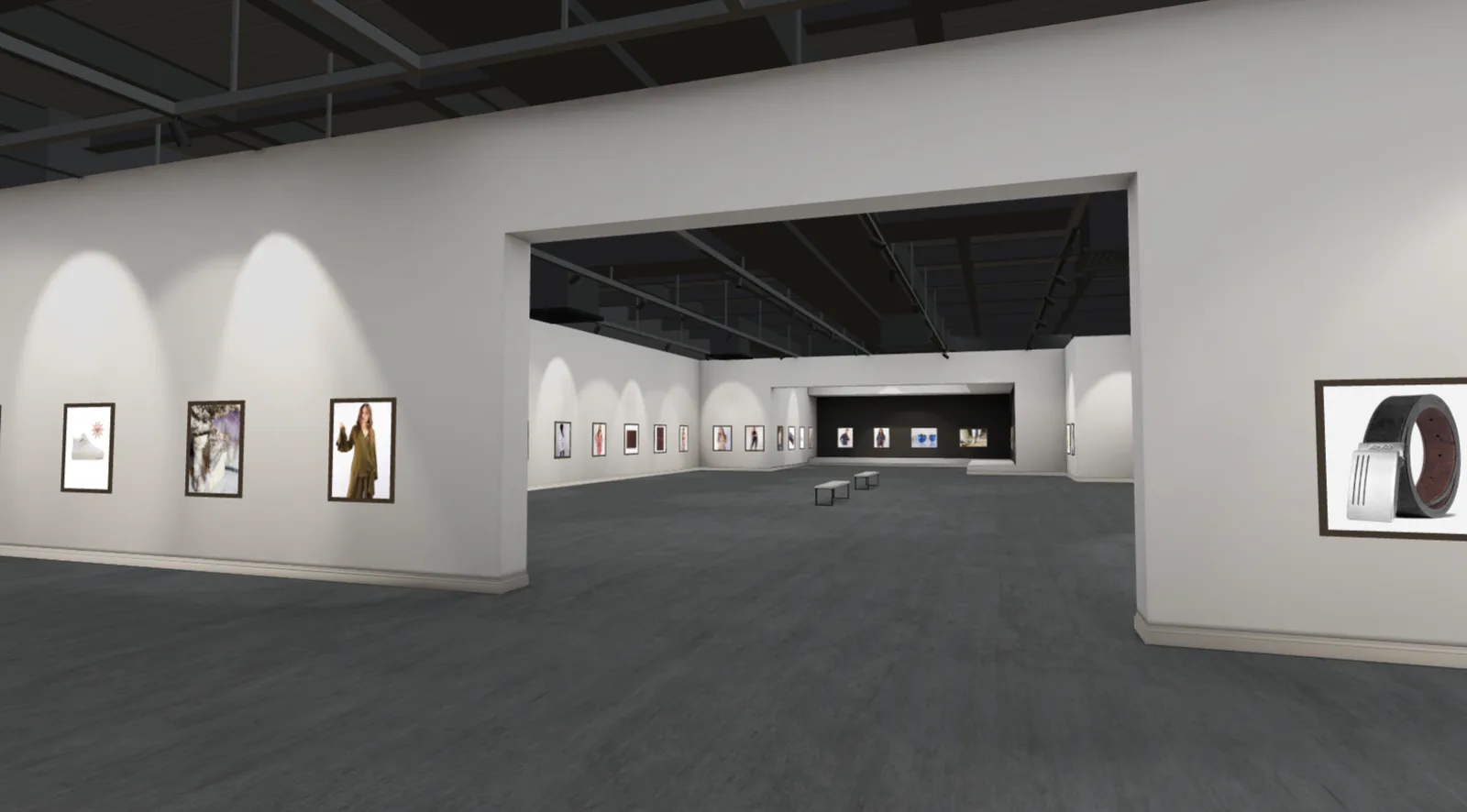Interior of a large white-walled 3D gallery, with framed pieces spotlit along the walls and a doorway opening through to a second room beyond